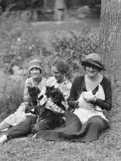 Egger, Gabrielle, Miss, and friends, with cats, seated outdoors, between 1926 and 1930. Creator: Arnold Genthe.