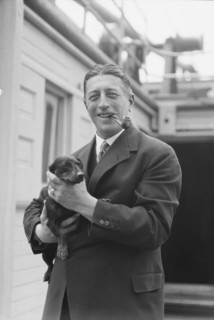Von Lueckner, Felix, Count, with dog, standing outdoors, 1931 June 5. Creator: Arnold Genthe.