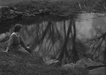 Millay, Edna St. Vincent, Miss, seated next to a pond, 1914. Creator: Arnold Genthe.
