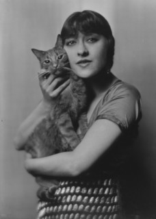 Dolly sister, with Buzzer the cat, portrait photograph, 1916. Creator: Arnold Genthe.