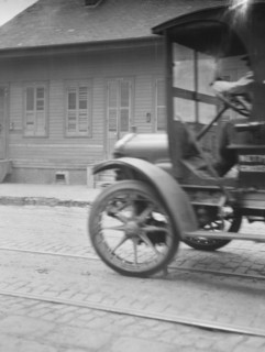 Car driving down a street, New Orleans or Charleston, South Carolina, between 1920 and 1926. Creator: Arnold Genthe.