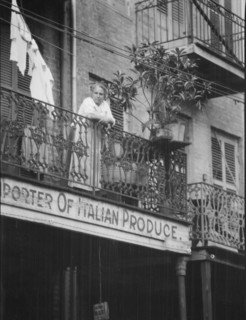 Woman leaning on a balcony, New Orleans, between 1920 and 1926. Creator: Arnold Genthe.