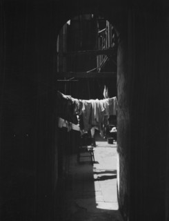 Courtyard with hanging laundry, New Orleans, between 1920 and 1926. Creator: Arnold Genthe.