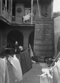 Courtyard with hanging laundry, New Orleans, between 1920 and 1926. Creator: Arnold Genthe.