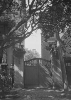 Gate between two buildings, New Orleans, or Charleston, South Carolina, between 1920 and 1926. Creator: Arnold Genthe.