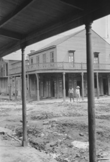 Two men crossing an unpaved street, New Orleans or Charleston, South Carolina, between 1920 and 1926 Creator: Arnold Genthe.