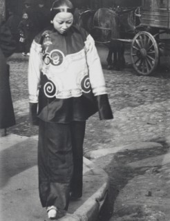 A woman in holiday attire, Chinatown, San Francisco, between 1896 and 1906. Creator: Arnold Genthe.