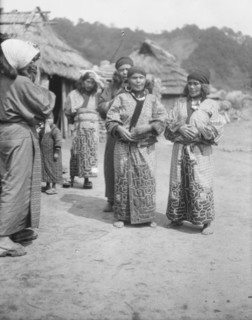 Ainu woman outside in the village lane, 1908. Creator: Arnold Genthe.