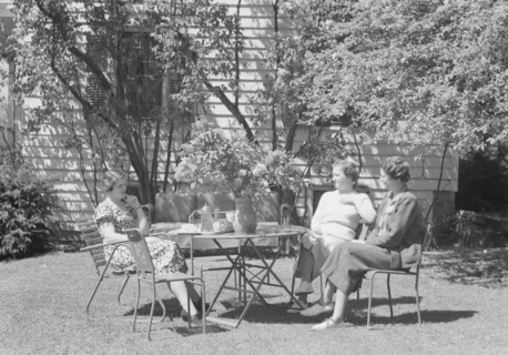 Mrs. Mary Benson and two identified women seated outdoors at a table, between 1933 and 1942. Creator: Arnold Genthe.