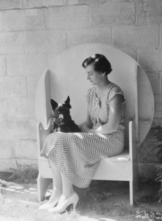 Mrs. Walter Fletcher with dog, seated outdoors, between 1933 and 1942. Creator: Arnold Genthe.