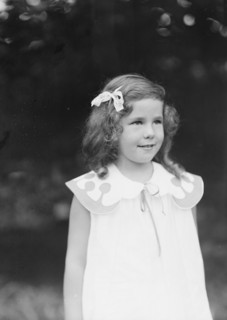 Daughter of W.G. Kimball, standing outdoors, between 1911 and 1942. Creator: Arnold Genthe.