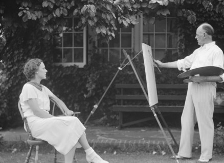 Mr. Hamilton King painting Mrs. Hamilton's portrait outdoors, between 1934 and 1942. Creator: Arnold Genthe.