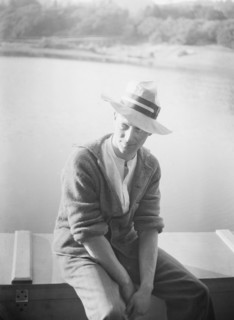 Unidentified man, seated in front of water, between 1896 and 1942. Creator: Arnold Genthe.