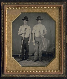 Occupational portrait of two men, standing full length holding floor rammers..., ca. 1850. Creator: Unknown.