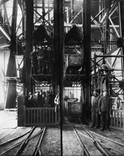 Hoisting ore & lowering miners, Lead Homestake Mine, between 1900 and 1910. Creator: William H. Jackson.