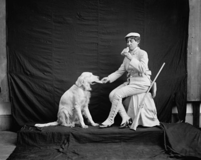 Billy and his mistress in hunting poses, between 1895 and 1910. Creator: Unknown.