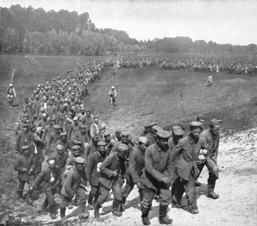 'Les "Douceurs" de la captivite; convoi de prisonniers en marche vers la gare..., 1916 (1924) Creator: Unknown.