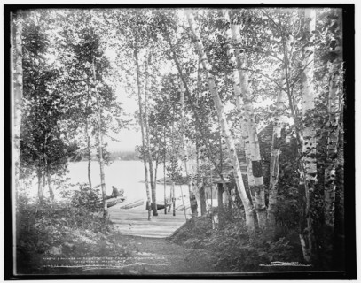 A glimpse of Raquette Lake from St. Hubert's Isle, Adirondack Mountains, c1902. Creator: William H. Jackson.