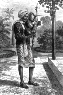 A strolling minstrel at Madras playing the tingadee, 1876. Creator: Unknown.