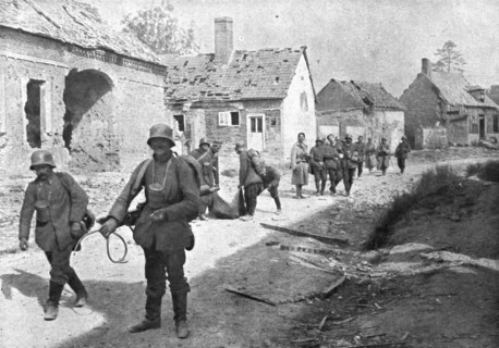 'A travers le champ de bataille; prisonniers allemands traversant un village reconquis..., 1918. Creator: Unknown.
