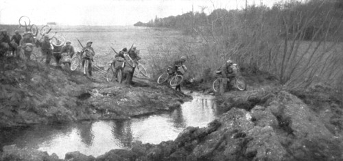 'L'avance Francaise; La traversee d'un ruisseau par un groupe cycliste: il existait la un petit pont Creator: Unknown.
