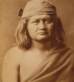 Native man, head-and-shoulders portrait, facing front, c1903. Creator: Edward Sheriff Curtis.