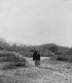 Pima woman, with burden basket on back, walking away from camera, Pima, Arizona, c1907. Creator: Edward Sheriff Curtis.