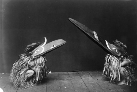 Kotsuis and Hohhug-Nakoaktok, wearing ceremonial dress, with long beaks, on their haunches..., c1914 Creator: Edward Sheriff Curtis.