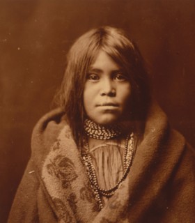 An Apache girl, head-and-shoulders portrait, facing front, wearing bead necklace..., c1903. Creator: Edward Sheriff Curtis.