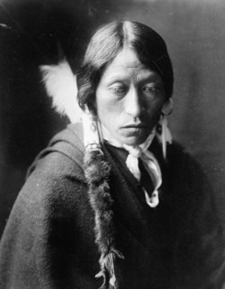 Jicarilla man, head-and-shoulders portrait, facing slightly right, with fur wrapped braids..., c1905 Creator: Edward Sheriff Curtis.