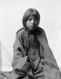 A Taos girl, three-quarter length portrait, seated, facing front, c1905. Creator: Edward Sheriff Curtis.