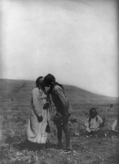 Atsina crazy dance-[A dancer kisses the grandfather], c1908. Creator: Edward Sheriff Curtis.
