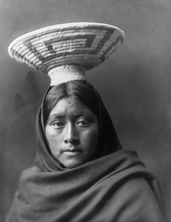 Papago Indian, Luzi, head-and-shoulders portrait, facing front, with a basket tray on her head,c1907 Creator: Edward Sheriff Curtis.