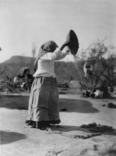 Papago cleaning wheat (Winnowing wheat), c1907. Creator: Edward Sheriff Curtis.