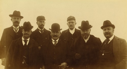 Seven men, half-length portrait, facing front,1894 or 1895. Creator: Alfred Lee Broadbent.