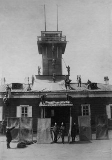 Irkutsk police fire brigade. Exercise with tarpaulins, shields, crowbar and hooks, 1894. Creator: R Prorokov.