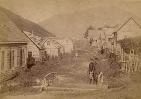 Main street in Petropavlovsk in Kamchatka. View of Mishennaya Sopka, 1890.  Creator: Unknown.