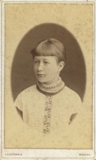 Head-and-shoulders portrait of a young woman, facing left, between 1880 and 1886. Creator: Unknown.