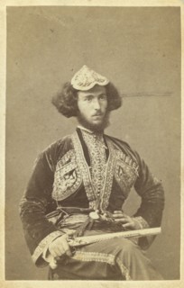 Three-quarter portrait of man, seated, facing right, between 1870 and 1886. Creator: Unknown.