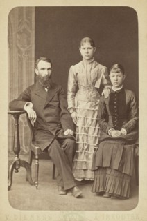 Family portrait of an unidentified man and his two daughters, 1885. Creator: Unknown.
