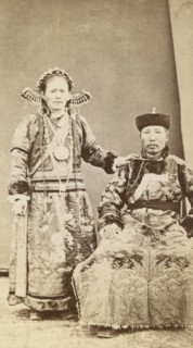 Full-length portrait of wealthy Buriat man and his wife, facing front, between 1870 and 1886. Creator: Unknown.