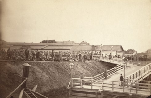 Group of convicts at head of inclined plane leading to barge, between 1885 and 1886. Creator: Unknown.