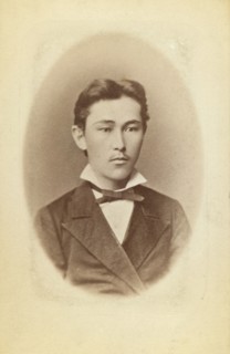 Half-length portrait of a young man, facing slightly right, between 1870 and 1886. Creator: Unknown.