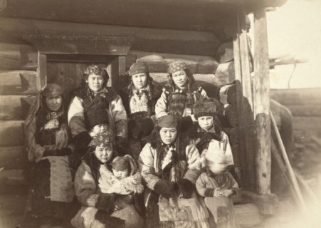 Tatar women with children seated in front of their home, between 1885 and 1886. Creator: Unknown.