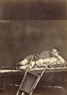 Hard Labor Convict Lying on a Bunk While Chained to a Wheelbarrow, 1891. Creator: Aleksei Kuznetsov.