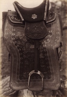 Saddle with Chinese Saddle-Cloth and Silver Mongolia Engraving over Iron, 1897. Creator: Unknown.