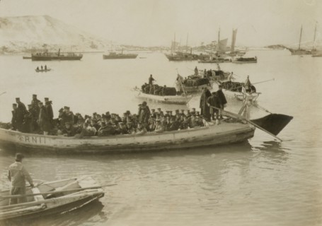String of pontoons in tow of stream launch, approaching landing stage, Chemulpo, c1904. Creator: Robert Lee Dunn.