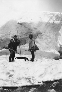 Eskimo with another man in winter scene, between c1900 and 1927. Creator: Lomen Brothers.