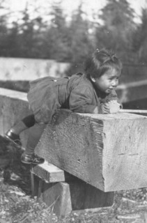 Eskimo child leaning on block of wood, 1905. Creator: Unknown.