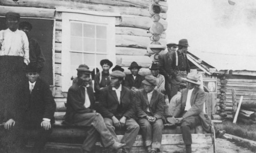 Indigenous peoples outside of log building, between c1900 and 1916. Creator: Unknown.